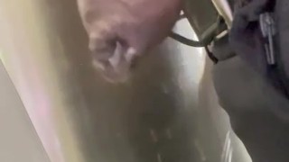 Drip hangs from uncut black dick while at work. 