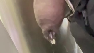 Drip hangs from uncut black dick while at work. 