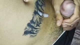 athletic guy pulls his cock until he cums on himself