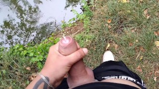 Thick uncut cock cums next to a pond
