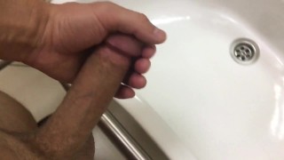 Cum flows down the wall of a public toilet