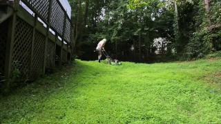Big fake tits halter top Daisy Dukes wearing crossdresser cutting the grass