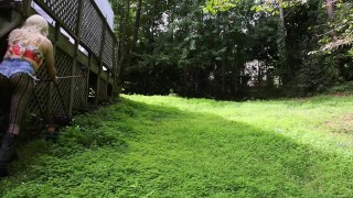Big fake tits halter top Daisy Dukes wearing crossdresser cutting the grass