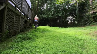 Big fake tits halter top Daisy Dukes wearing crossdresser cutting the grass