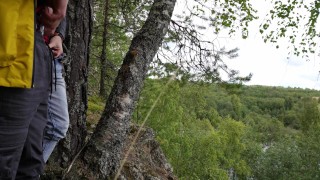 Two tight streams of urine cross in the mountains. Pissing outdoor UHD 4K video