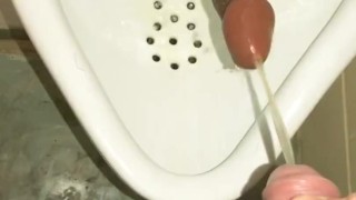 Pissing at a urinal first thing in the morning with my friend dildo 