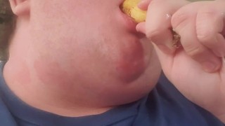 Fat male testing throat with banana