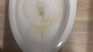 Peeing in a bathroom stall