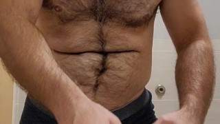 Muscle bear strips off dress pants to show off cock