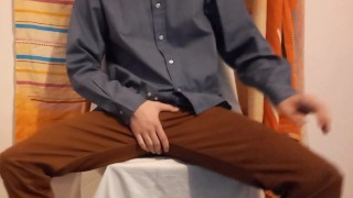 Man in suit grabbing his bulge