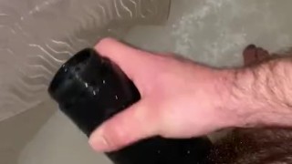 Young hairy daddy plays with flashlight in shower
