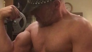 Naked horny muscular cop wearing his police hat turns himself on flexing his big bicep and cums