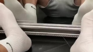 Guy sniffs white Nike socks