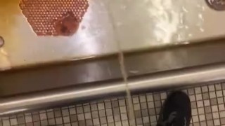 Taking a piss at an old urinal trough