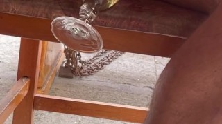 Pissing in a glass and drinking in public in a street restaurant