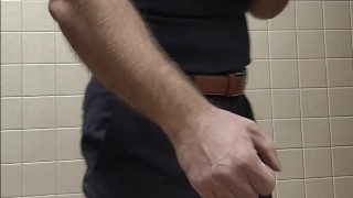 Muscle bear flexing in black tank top