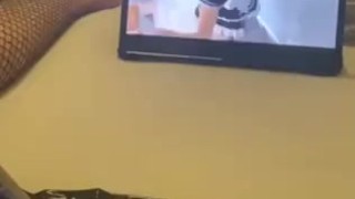 Sissy is watching porn and gets horny in chastity cage