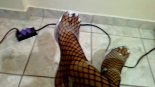 White long toenails in black fishnets and clear heels