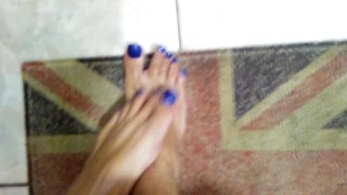 Oilying long blue toenails and feet