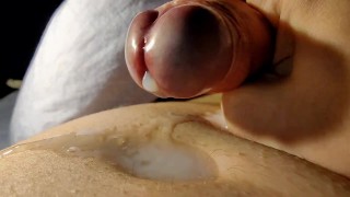Up Close hand job over big cock head, cum pool, uncut cock