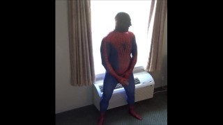spiderman in black silicone mask jerking off at hotel window