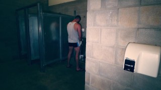 Hunk muscle jock jerks off his big cock in a public bathroom