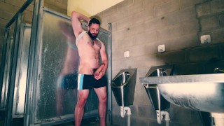 Furry muscle hunk shows off his big thick cock at the public urinal
