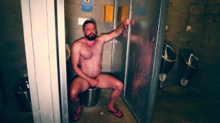 Furry muscle hunk gets himself off in a public bathroom