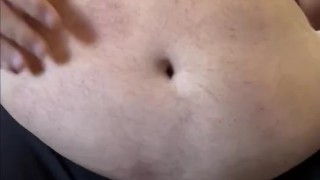 Big daddy bear playing with his hefty belly