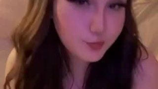 Busty babe plays with her tits