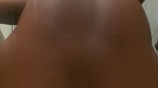 Mulatto pisses from a big dildo in the ass