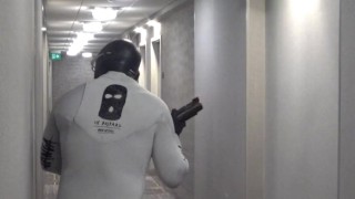 horny wetsuited armed guard patrolling hotel hall