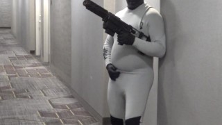 horny wetsuited armed guard patrolling hotel hall