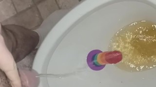 Sean pisses on then rides a pride cock