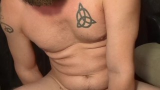 bearded guy rides a dildo