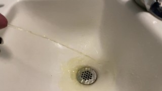 Slow mo pissing in the sink