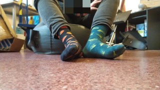 Twink boy feet in different colored socks in school