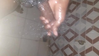 African teen mastrubating in the shower with his big cock