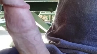Hot guy hanging out at the park. Playing with his big dick at a public picnic table