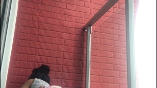 Lesbians have public sex on the balcony of the apartment.