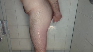 Caged cuckold takes out large butt plug in the shower