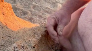 Naked on the beach wanking and cuming on the rock