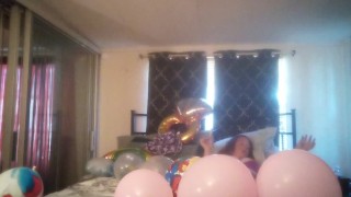 Milf with extreme long hair popping balloons and smoking cigarettes while filming up her own skirt