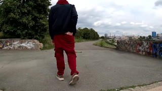 handsome guy masturbates his big dick on the embankment in extreme