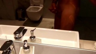 Showing cum on hand after jerking off at hotel toilet