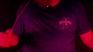 Masturbating illuminated by a deep red light