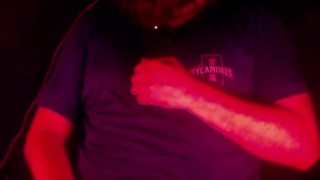 Masturbating illuminated by a deep red light