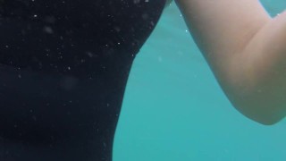 Blue water, black swimsuit, beautiful legs