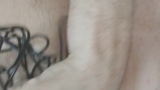 horny man constricts his penis with cable and cums at the same time