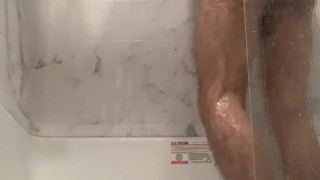 Hot guy cleans himself in the shower.